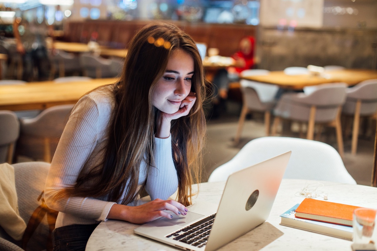 cute girl works laptop hipster cafe scaled Large